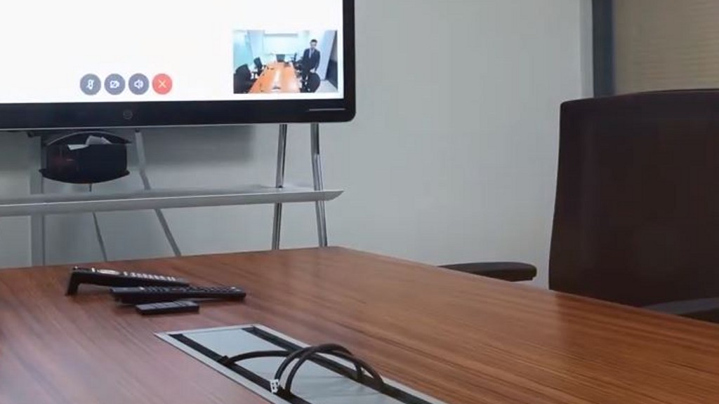 A close up of a meeting room table with a place for technology hook-ups designed into the center of the table.