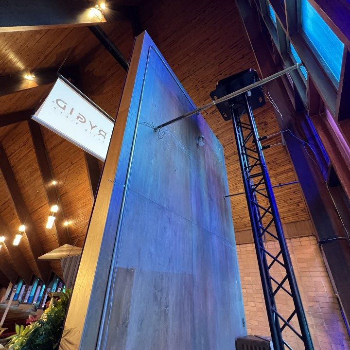 A digital projector atop a frame is concealed behind a wall so it doesn't distract from the aesthetic of the church.