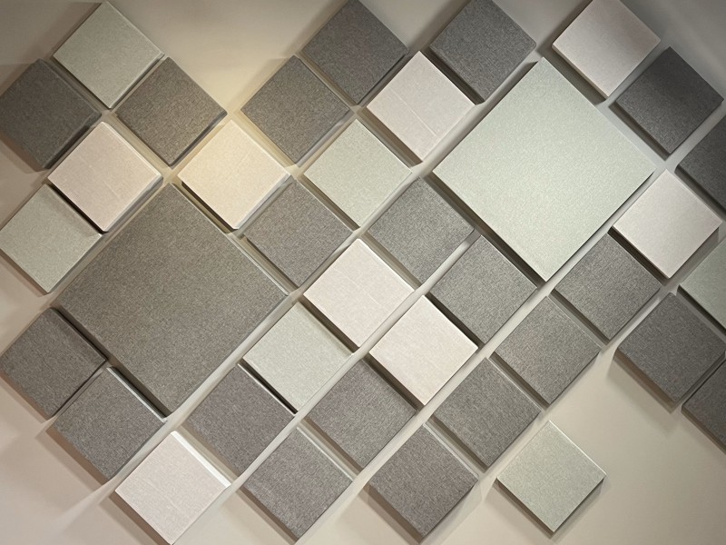 Acoustic sound panels on the wall doing what do acoustic panels do which is absorbing sound.
