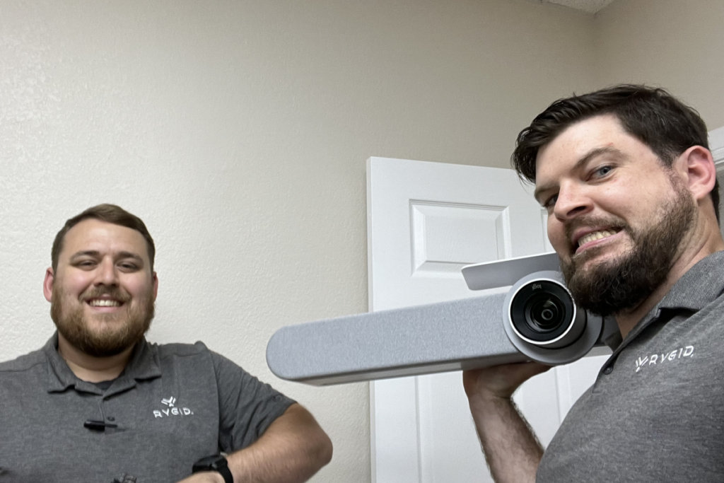 Two professional AV installers from RYGID AV posing with modern AV equipment, demonstrating expertise and friendly service. What is an AV installer? Ask our team!