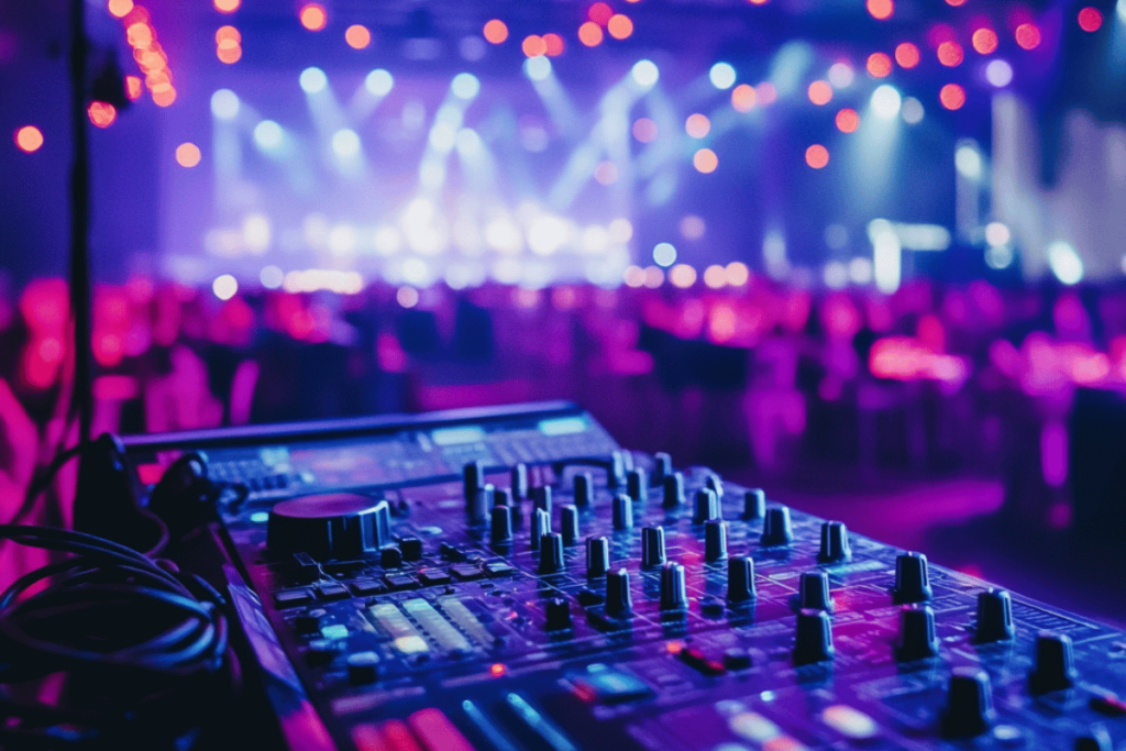 Close-up of an audio mixer with various dials and sliders, set up for a live event, illustrating the technical expertise of AV professionals.