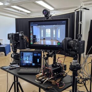 A professional live-streaming setup with multiple cameras, screens, and a laptop in a classroom, designed for streaming educational content to remote learners.